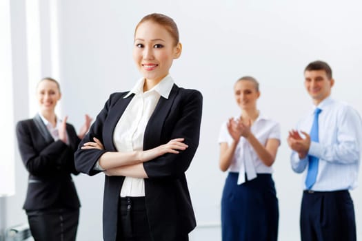 Image of four pretty young businesswomen standing in row