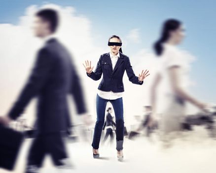 Image of businesswoman in blindfold walking among group of people