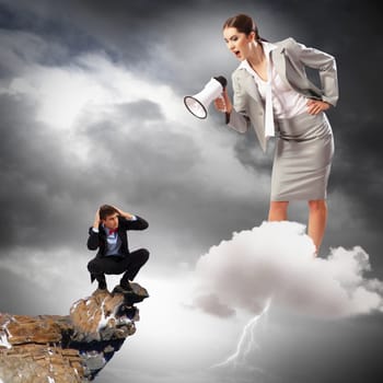 Angry businesswoman with megaphone shouting at colleague