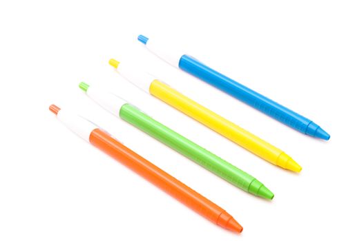 colored pens on a white background