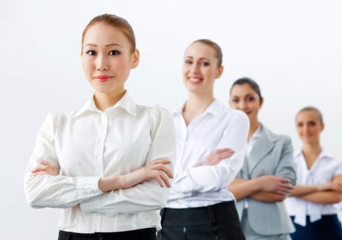 Image of four pretty young businesswomen standing in row