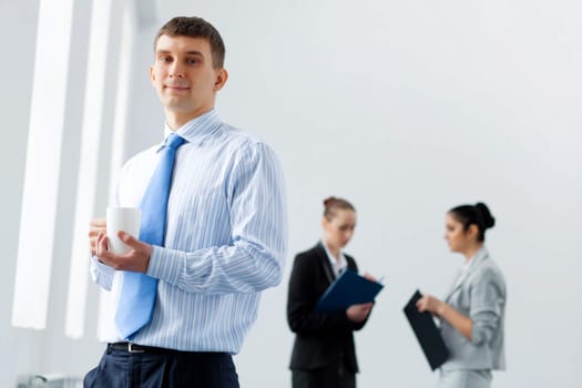 Image of three young businesspeople laughing joyfully