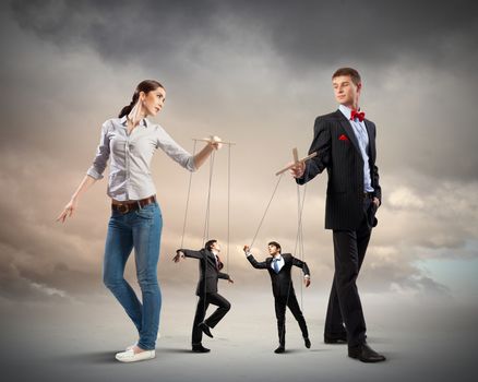 Image of man and woman with marionette puppets