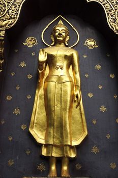 Ancient golden Buddha statue in an old wat of Chiang Mai, Thailand