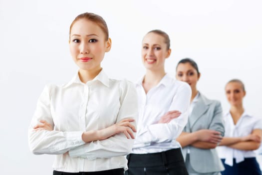 Image of four pretty young businesswomen standing in row