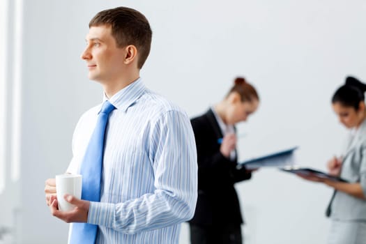 Image of three young businesspeople laughing joyfully