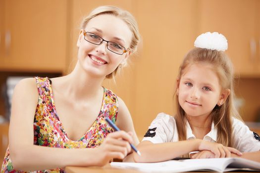 Young female teacher working with children at school