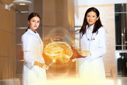 Image of two women doctors examining results