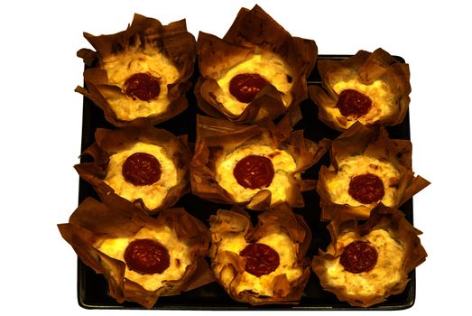 Small homemade pies with cheese and cherry tomato in a basket of pastry