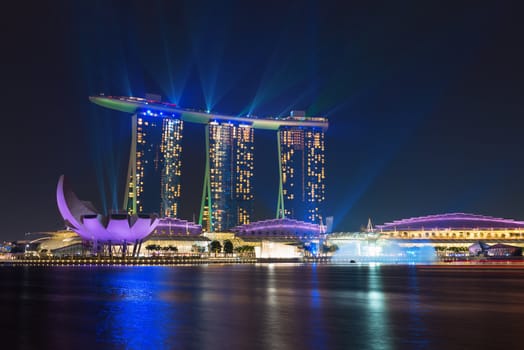 SINGAPORE - SEP 9: Marina Bay Sands illuminated by night  laser show on Sep 9, 2012  in Singapore. it is billed as the world's most expensive standalone casino at 8 billion SGD