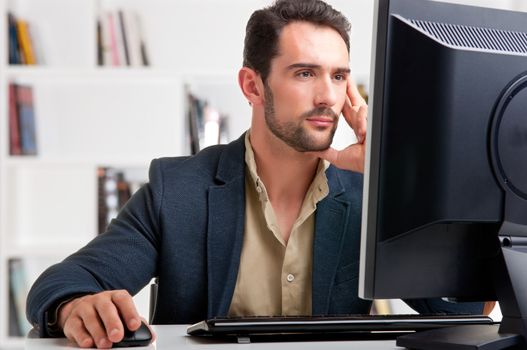 Man looking at a computer screen, thinking about the job at hand