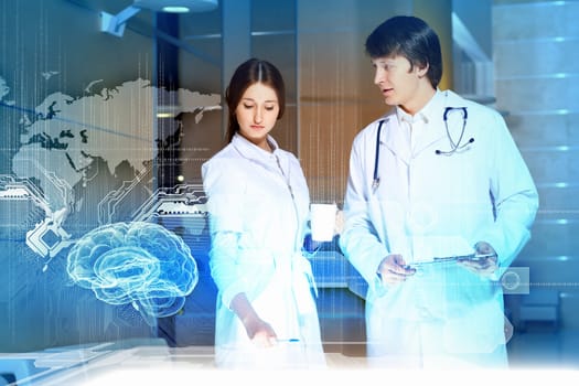 Image of two young doctors examining futuristic image of brain