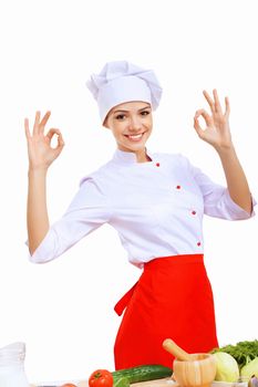 Young cook preparing food wearing a red apron