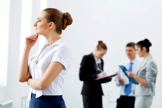 Image of four pretty young businesswomen standing in row