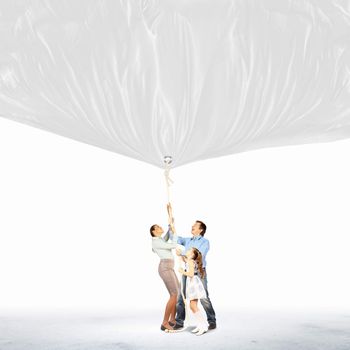 Image of young happy family pulling blank banner