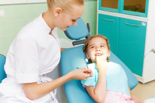 Little girl sitting in the dentists office