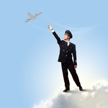 Image of pilot touching sky against airplane background