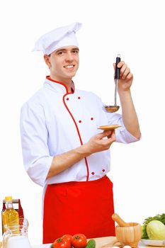 Young cook preparing food wearing a red apron