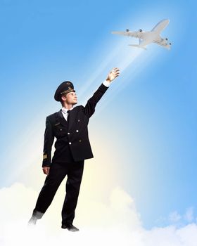 Image of pilot touching sky against airplane background