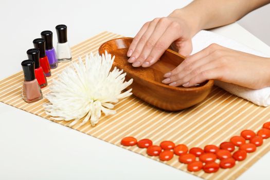 Young woman is getting manicure in a beauty salon