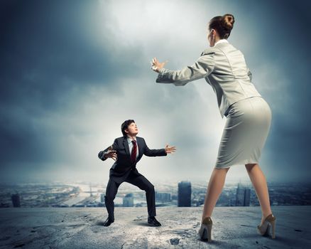 Image of businesspeople arguing and acting as sumo fighters