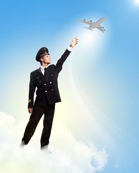 Image of pilot touching sky against airplane background