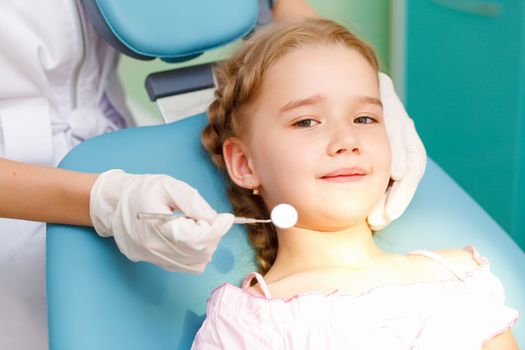 Little girl sitting in the dentists office