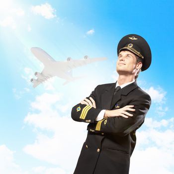 Image of male pilot with airplane at background