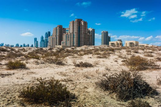 DUBAI, UAE - NOVEMBER 17: Midday heat in the desert in the background buildingsl on Nov 17, 2012 in Dubai UAE