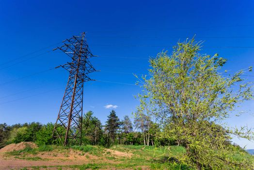 High-voltage power line on the shore of the river