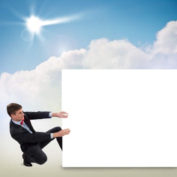 young man holding a blank banner, place for text