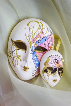 Venetian mask on the background of draping of organza