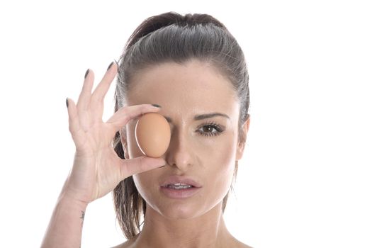 Model Released. Young Woman Holding a Brown Egg