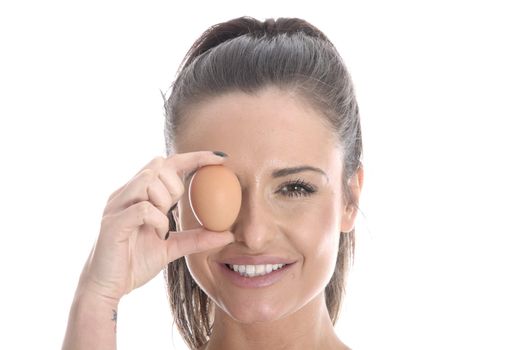 Model Released. Young Woman Holding a Brown Egg