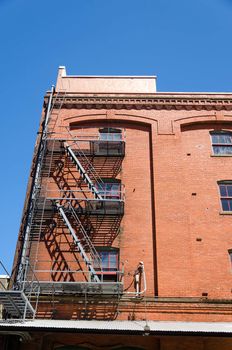 Fire escape running down the side of a red brick building in Portland, Oregon