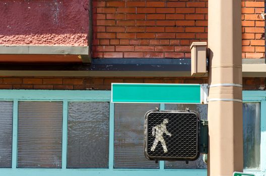 Traffic Signal showing a walking sign with a blank street name in Portland, Oregon