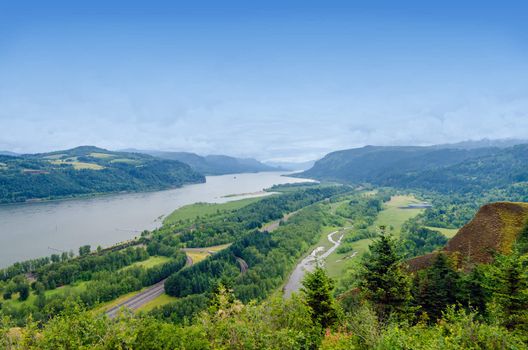 View of the lush green Columbia River Gorge in Oregon with I-84 visible