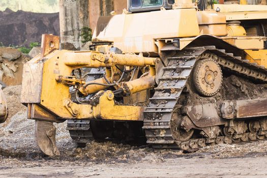 Bulldozer machine doing earth moving work in construction site
