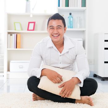 Young Asian man smiling happy. Lifestyle Southeast Asian man at home. Handsome Asian male model.