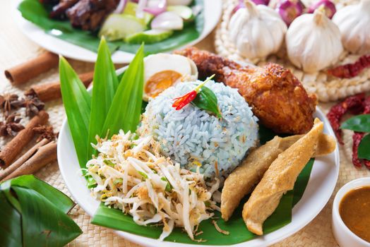 Nasi kerabu or nasi ulam, popular Malaysian Malay rice dish. Blue color of rice resulting from the petals of butterfly-pea flowers. Traditional Malaysia food, Asian cuisine.