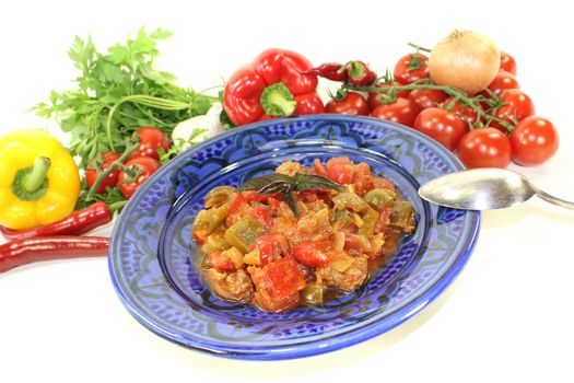 Moroccan Tagine Kefta with tomatoes, peppers and ground beef on a bright background