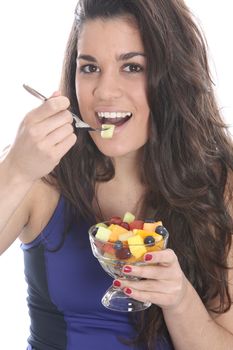 Model Released. Young Woman Eating Fresh Fruit Salad