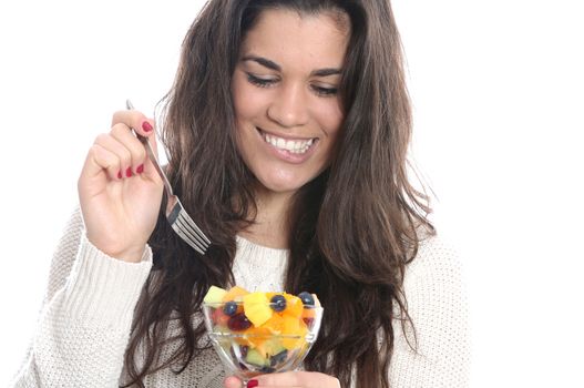 Model Released. Young Woman Eating Fresh Fruit Salad