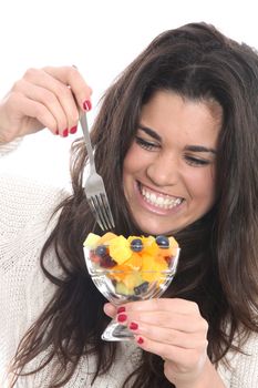 Model Released. Young Woman Eating Fresh Fruit Salad