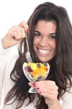 Model Released. Young Woman Eating Fresh Fruit Salad