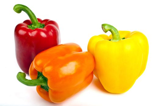 Three Bell Peppers over a white background.