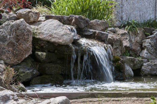 waterfall next to a lake