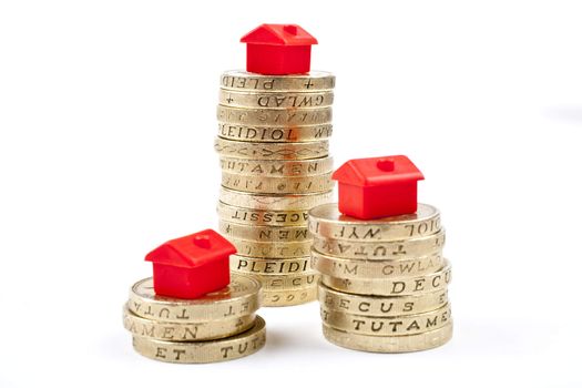 �1 Coins Stacked up in three piles.  Saving for a Home.