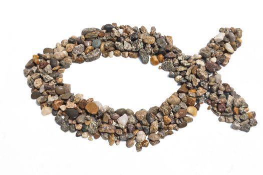 An ichthus made of pebbles against a white background.