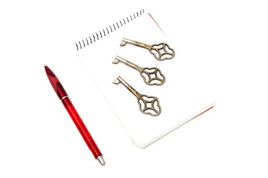 notepad with keys on a white background